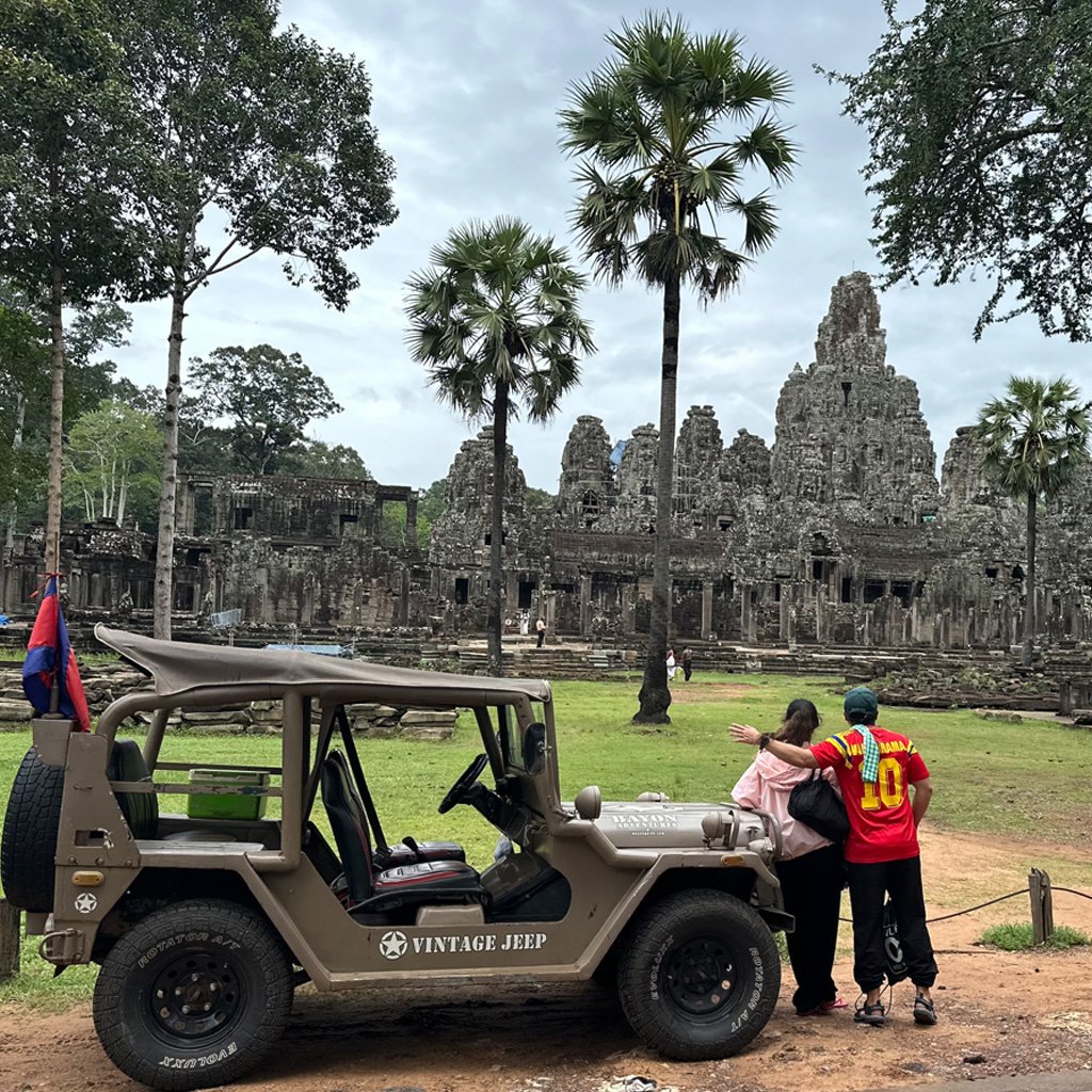 Happy Travelers and Jeep at Bayon